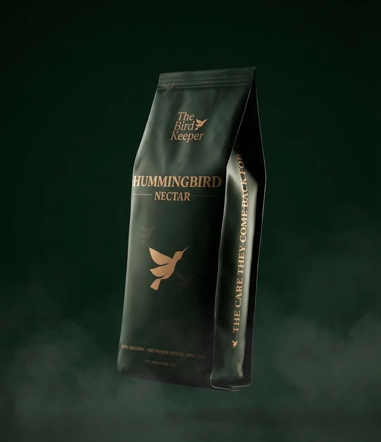 The Bird Keeper Hummingbird Nectar — premium dark green pouch with gold typography